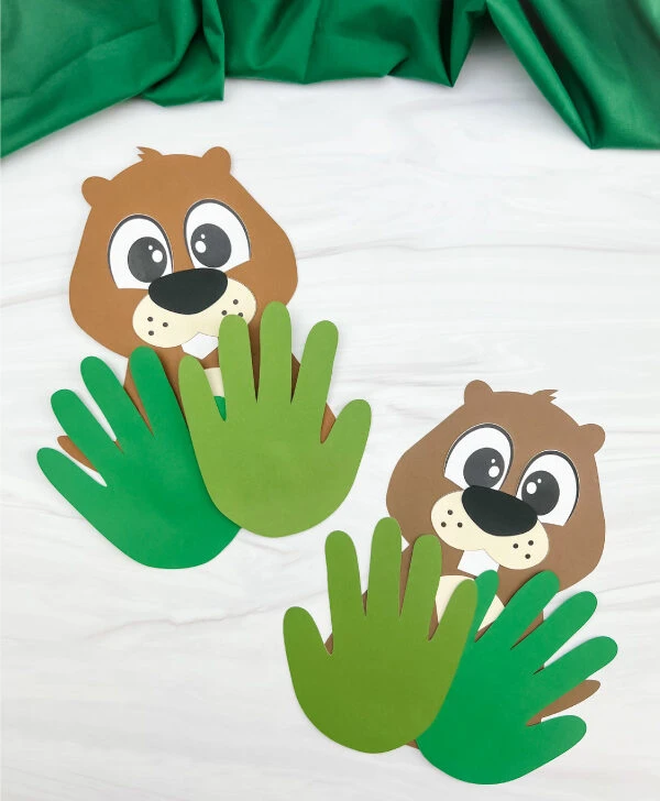 two finished examples of groundhog handprint craft