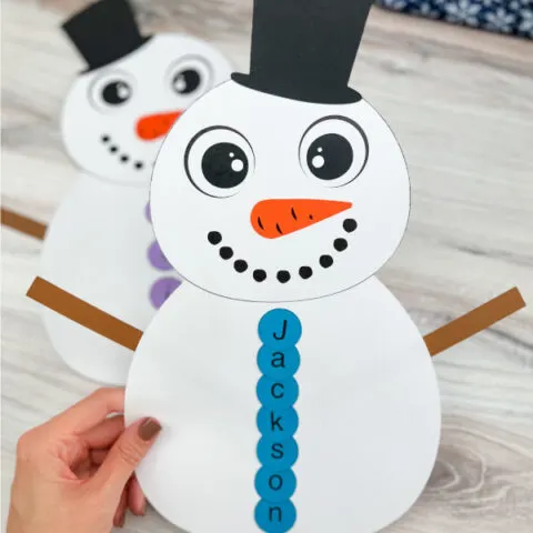 hand holding a snowman name craft finished