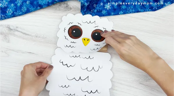 hands gluing body to owl babies puppet craft