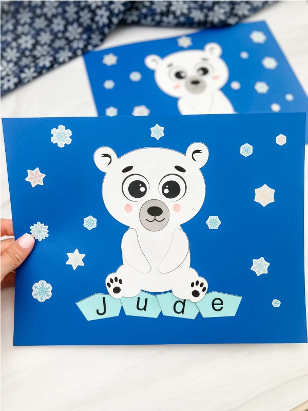 hand holding finished polar bear name craft with one in background