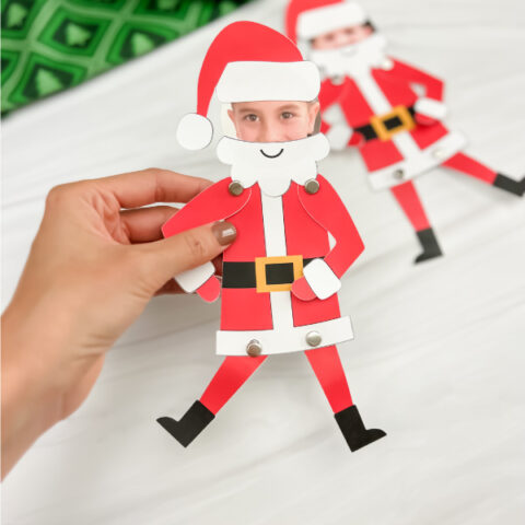 hand holding finished Santa photo craft with another one in background