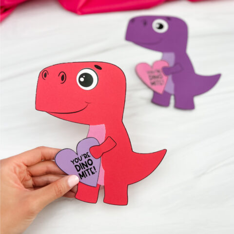 hand holding red dinosaur valentine craft