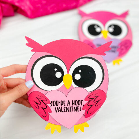 hand holding finished valentine owl craft with another finished owl in background