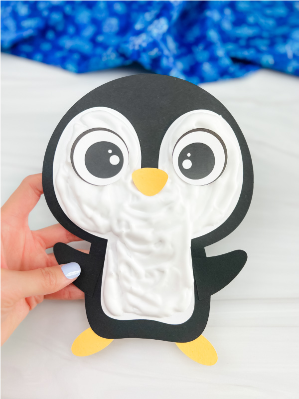 holding the puffy paint penguin craft
