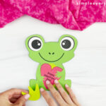 hand gluing frog legs onto body