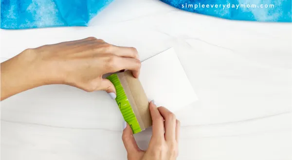 hands rolling the colored template onto the toilet paper roll