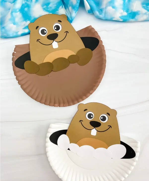 two examples of finished groundhog paper plate craft