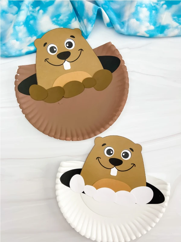two examples of finished groundhog paper plate craft