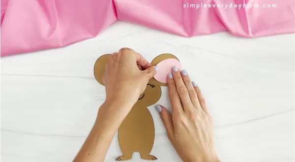 hands gluing ear onto mouse valentine craft