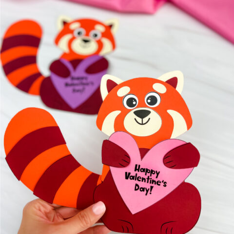hand holding finished example of red panda valentine craft with another example in background
