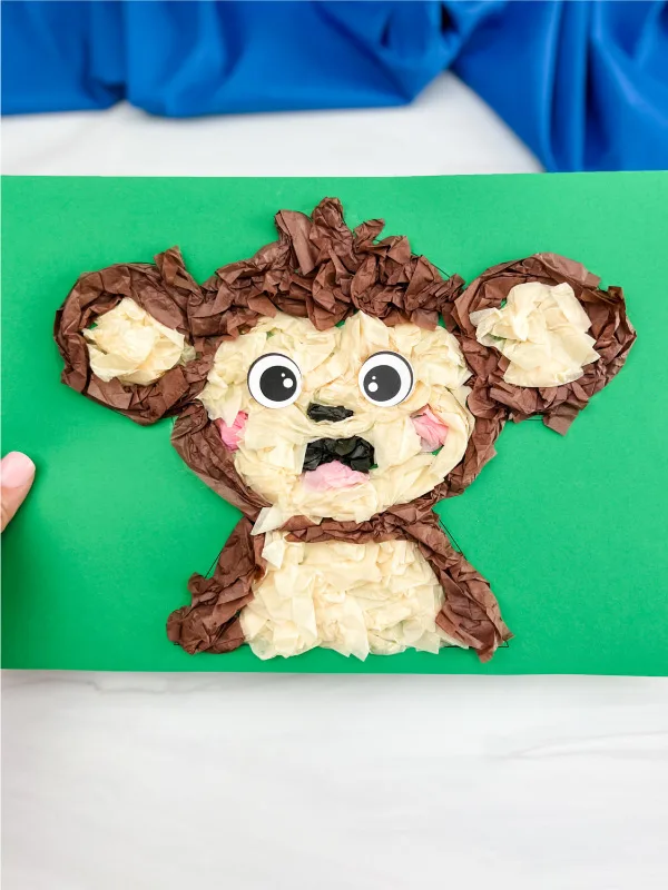 hand holding finished monkey tissue paper craft