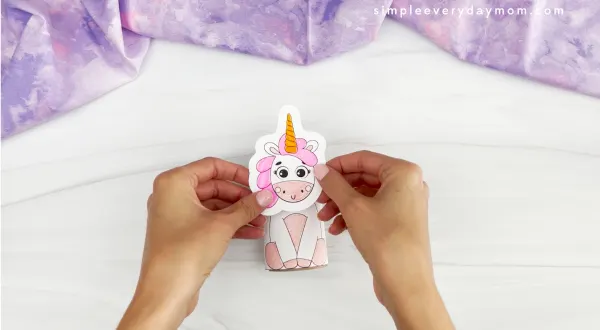 hands gluing unicorn head to unicorn body