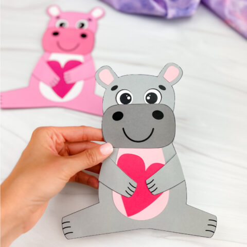 hand holding finished hippo valentine craft gray in color