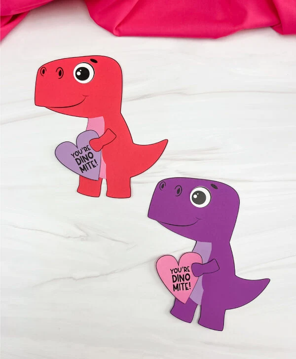 two finished examples of dinosaur valentine craft. red and purple
