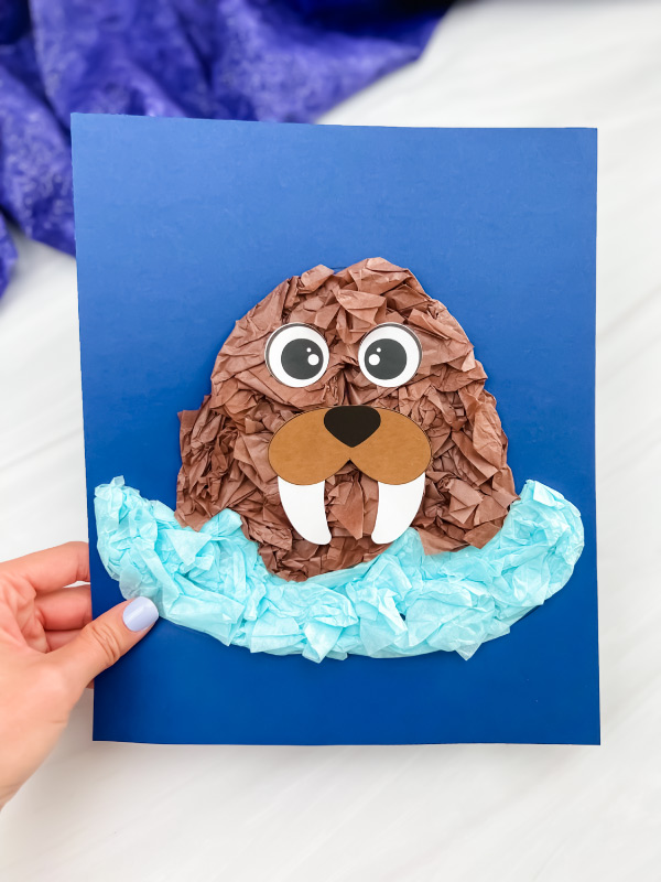 hand holding single image of finished walrus tissue paper craft