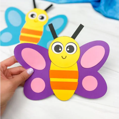 hand holding finished purple butterfly shape craft