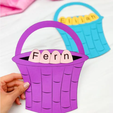 hand holding finished example of Easter basket name craft in purple