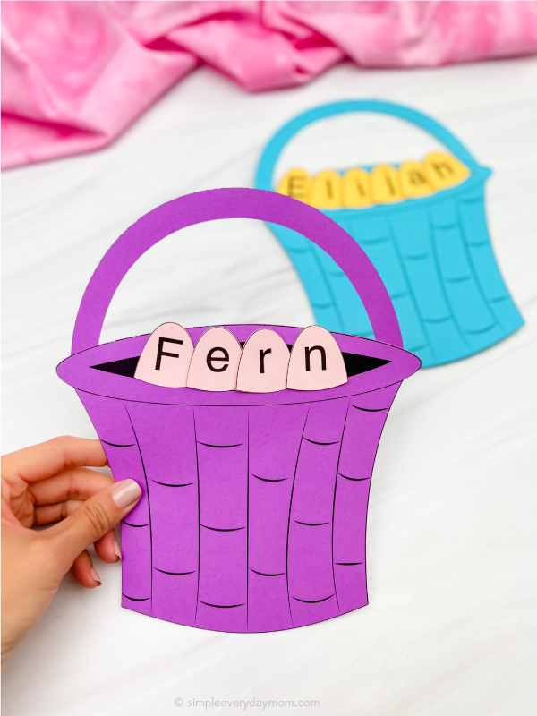 hand holding finished example of Easter basket name craft in purple