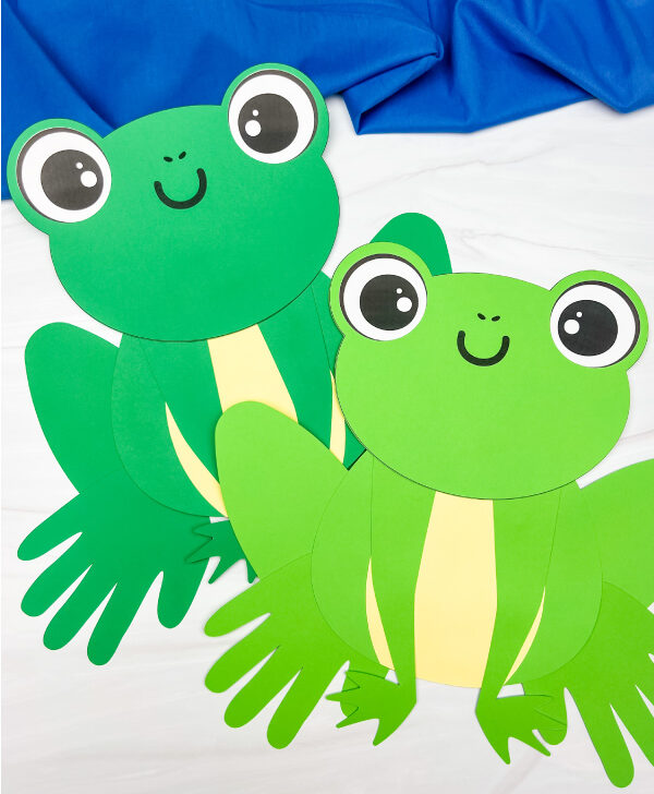 two finished examples of frog handprint craft