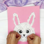hands gluing mouth onto bunny face