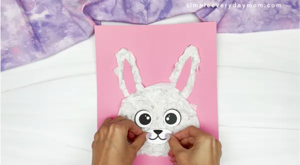 hands gluing mouth onto bunny face