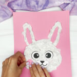 hands gluing cheeks onto bunny face