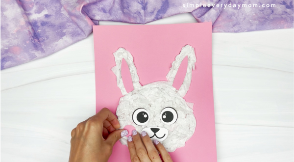 hands gluing cheeks onto bunny face