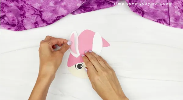 hands gluing ears onto bunny gnome craft