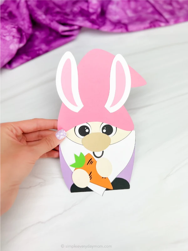 hand holding finished bunny gnome craft