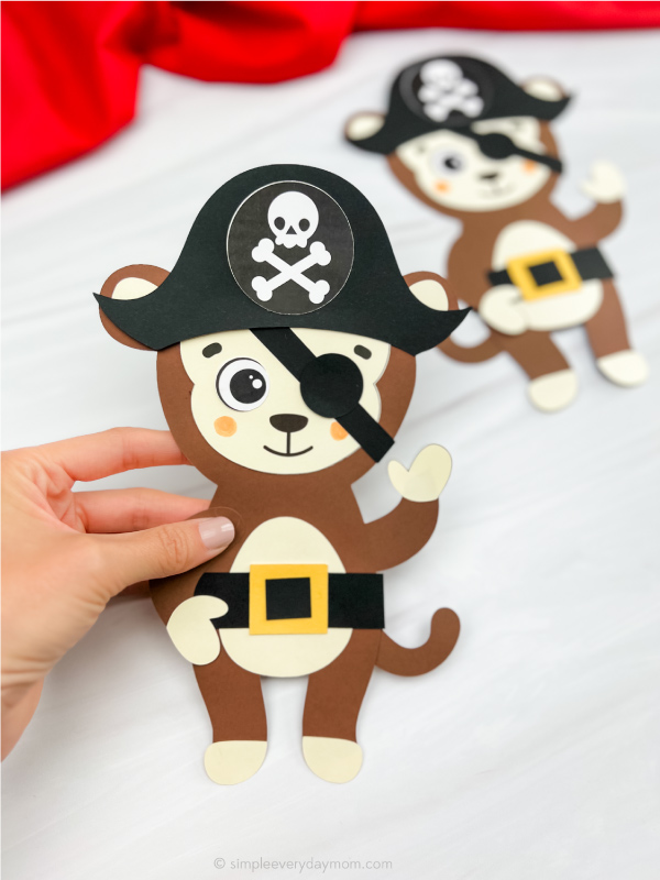 hand holding finished pirate monkey craft with another in background