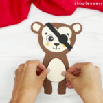 hands gluing monkey stomach onto monkey