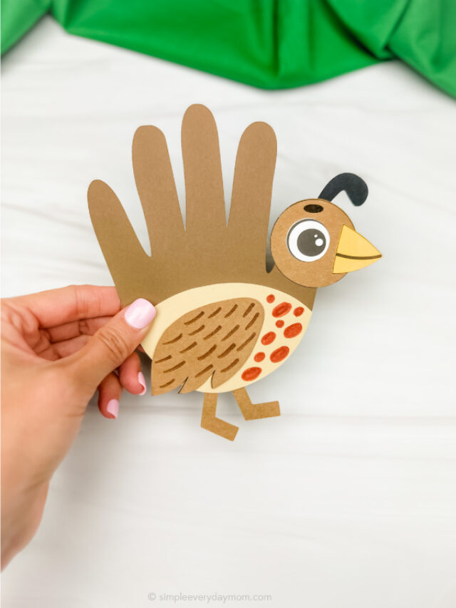 hand holding single quail handprint craft