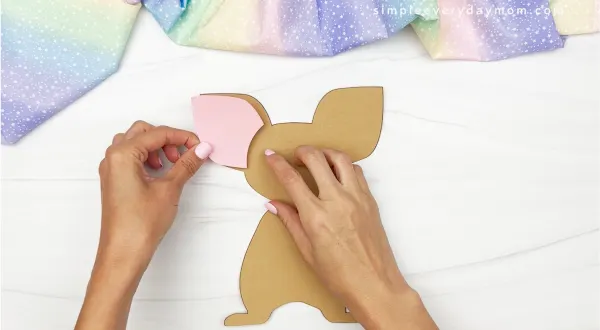hands gluing ear onto mouse