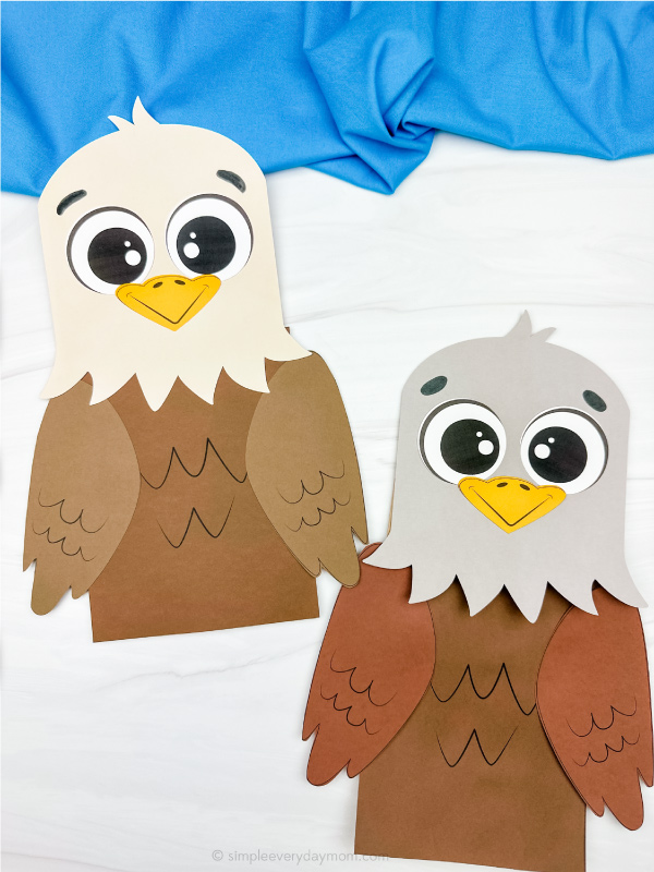 two examples of finished eagle paper bag puppet