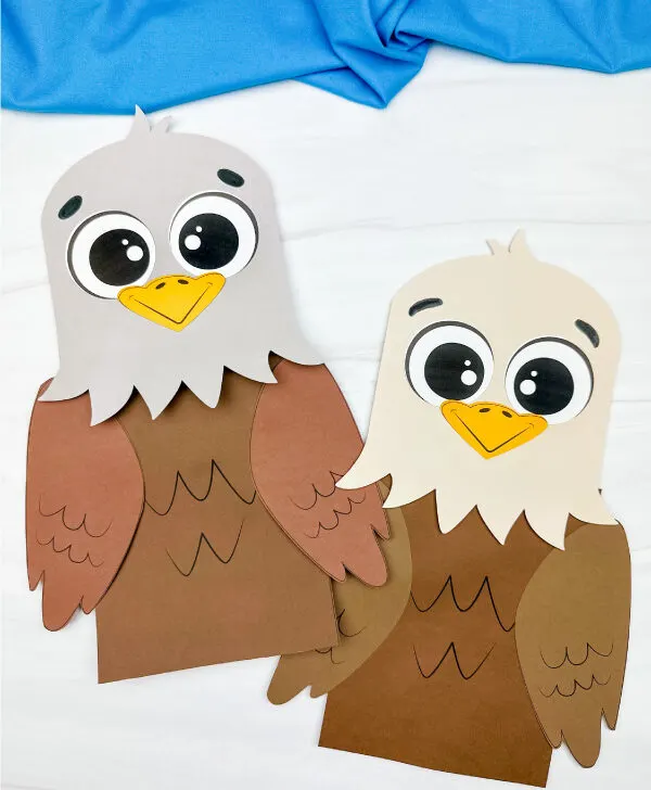 two side by side examples of finished eagle paper bag puppet