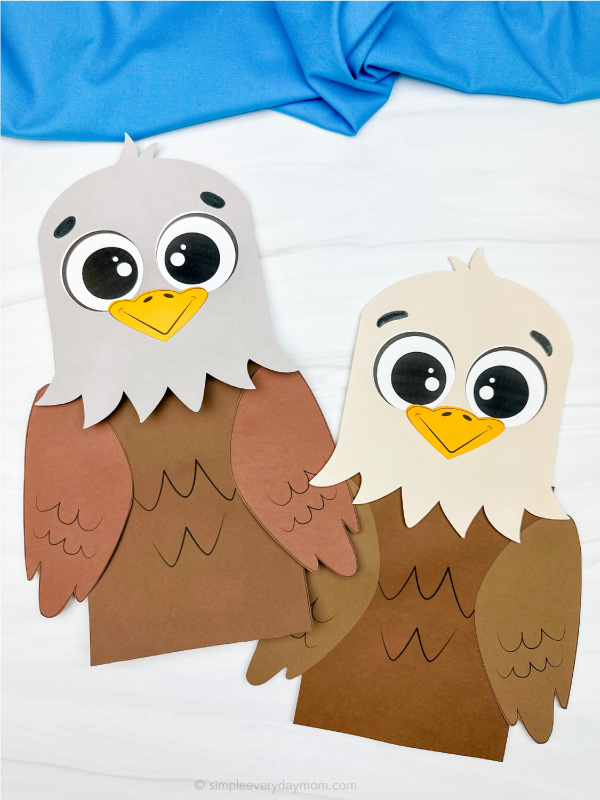 two side by side examples of finished eagle paper bag puppet