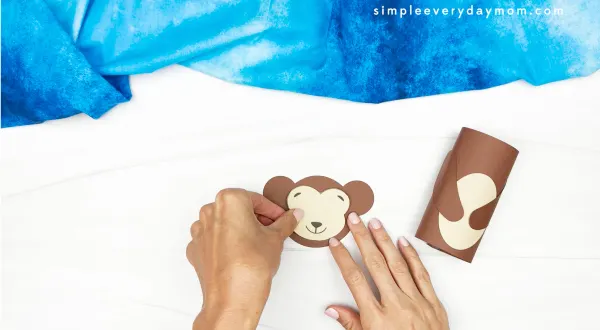 hands gluing face to monkey