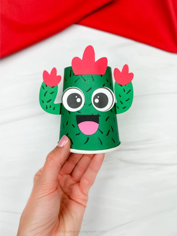 hand holding finished cactus paper cup craft