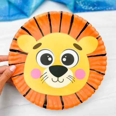 hand holding example of finished lion paper plate