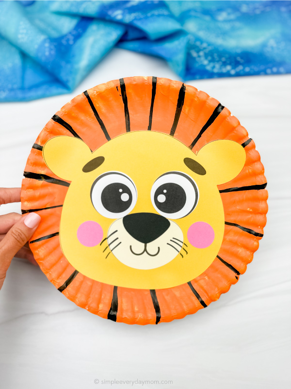 hand holding example of finished lion paper plate
