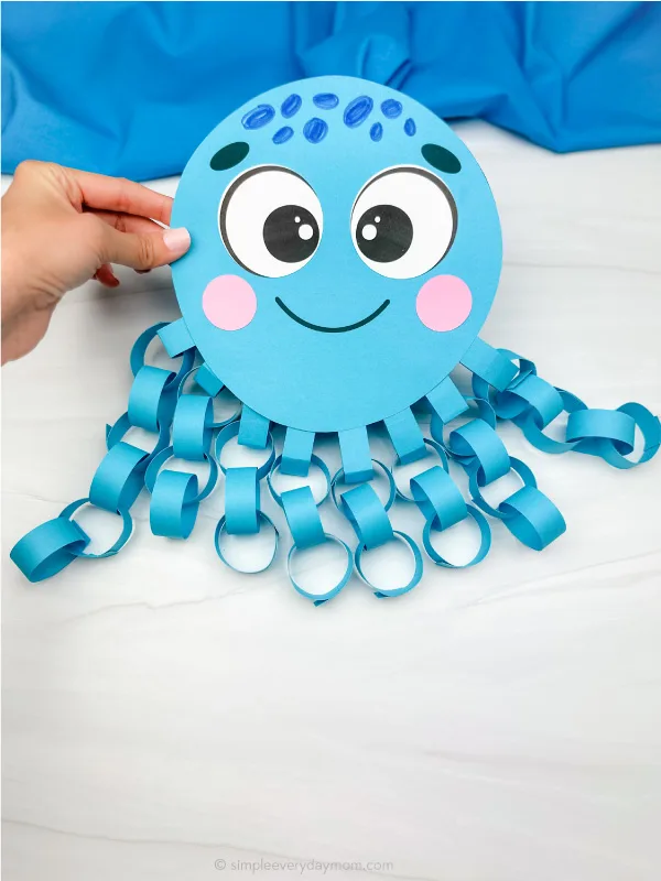 hand holding finished paper chain octopus craft