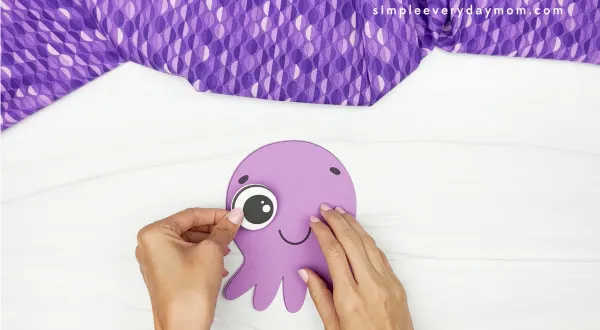 hands gluing eye onto octopus face