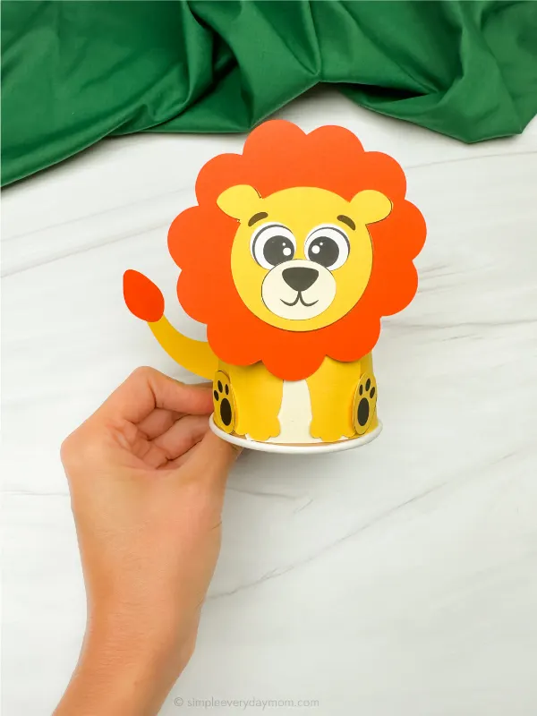 hand holding lion paper cup craft