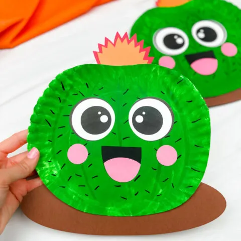 hand holding paper plate cactus craft with another in background
