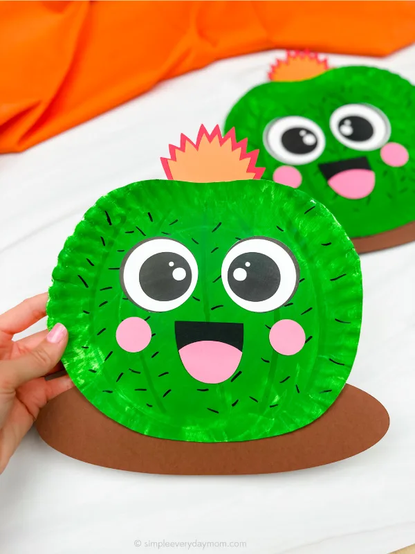hand holding paper plate cactus craft with another in background
