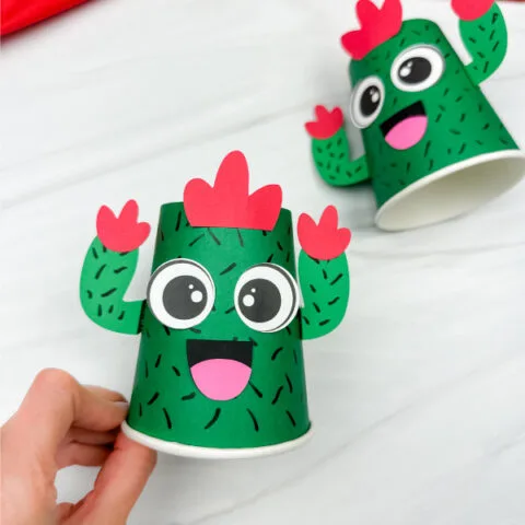 hand holding cactus paper cup craft with another in the background