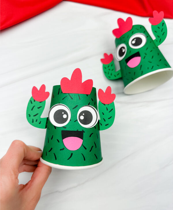 hand holding cactus paper cup craft with another in the background