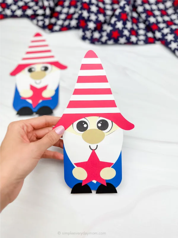 hand holding finished patriotic gnome craft with another in background