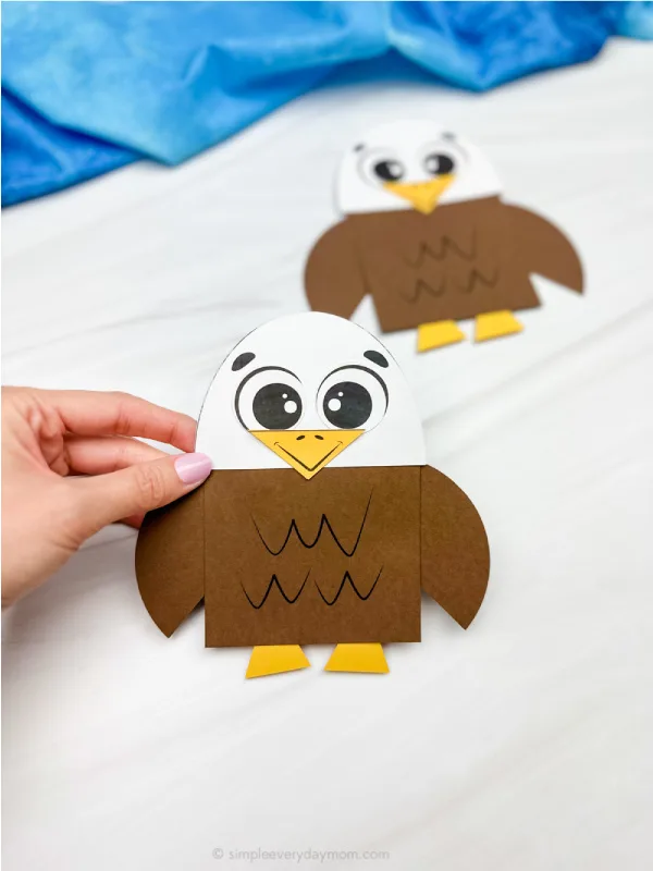 hand holding bald eagle shape craft with another example in background