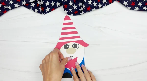 hands gluing star onto gnome